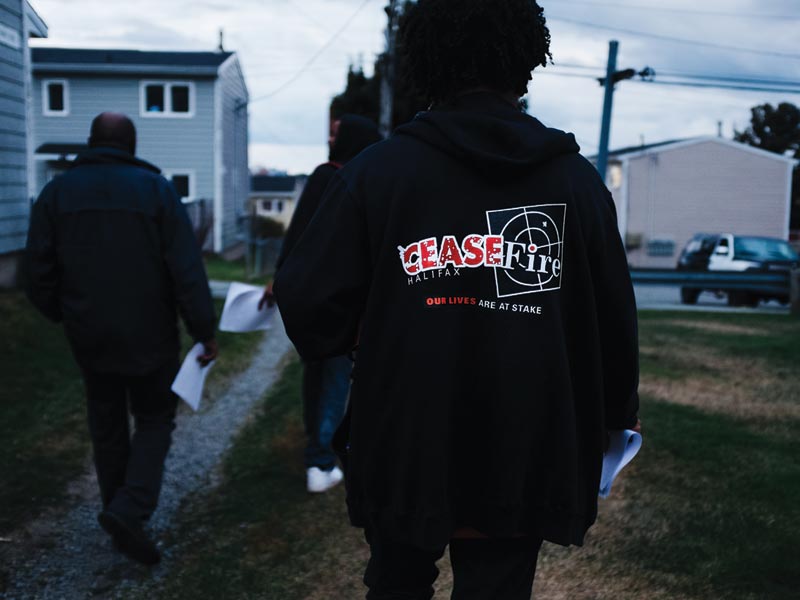 Members of the CeaseFire Halifax team canvas a neighbourhood in Dartmouth, spreading the word about the program. Its mandate is to reduce gun violence by using a model that treats violence as a disease. Photo: Randal Tomada