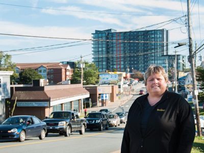 Lisa Sullivan is the operations manager at Freeman’s Little New York on Dutch Village Road in Fairview. She is excited about the new developments in her longtime neighbourhood, including  St. Lawrence Place, pictured here in the background. Photo: Rachael Shrum
